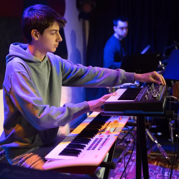 Aluna a analisar uma pauta musical durante a aula de piano na Academia Música Bloom em Benfica.